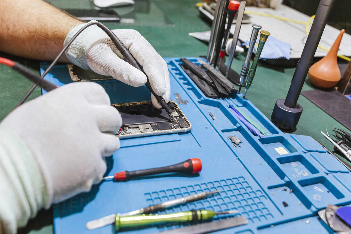 Electronics Garden Repair technician repairing a phone at our NYC repair shop near Penn Station